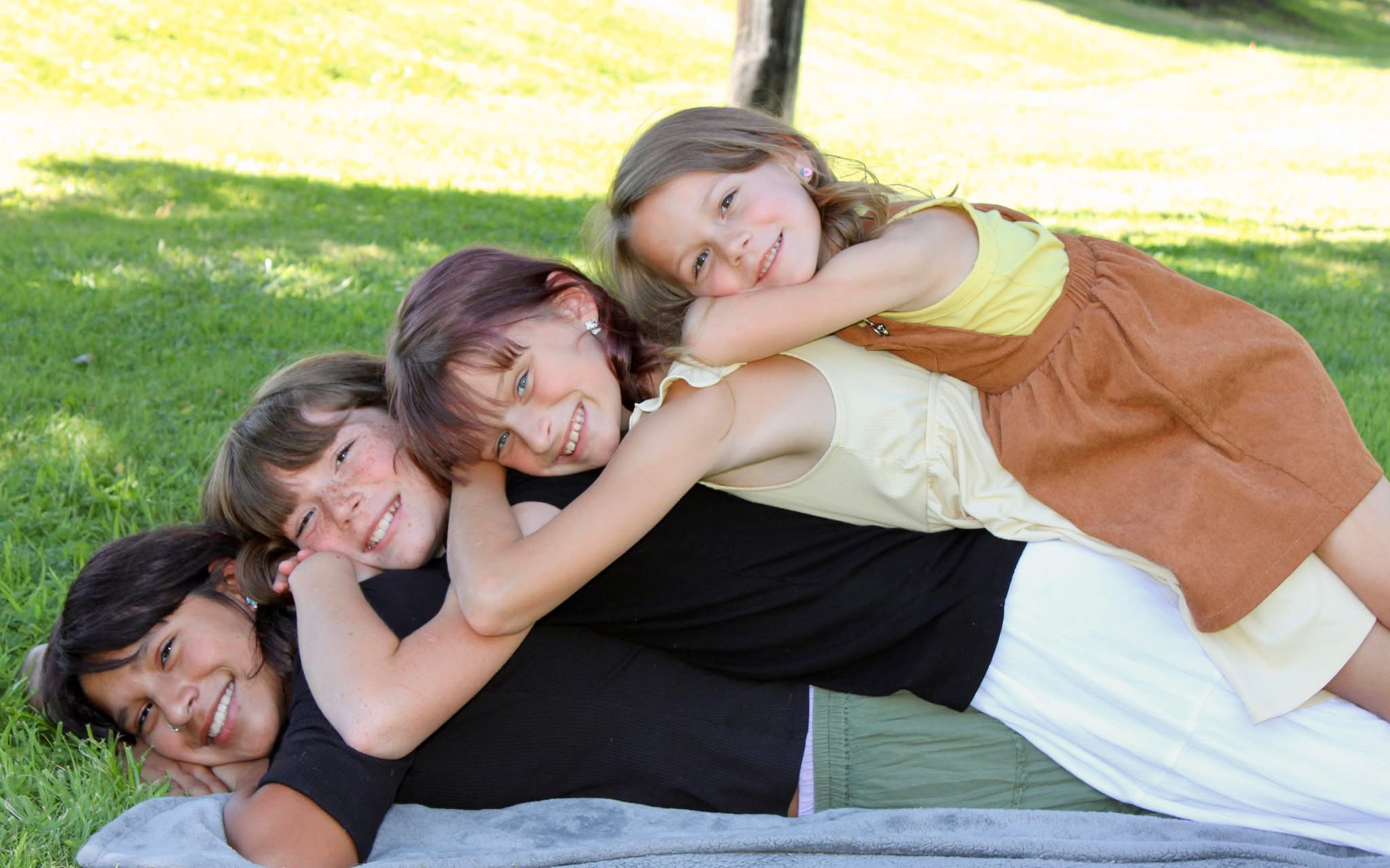 Amanda’s four daughters smiling together outside